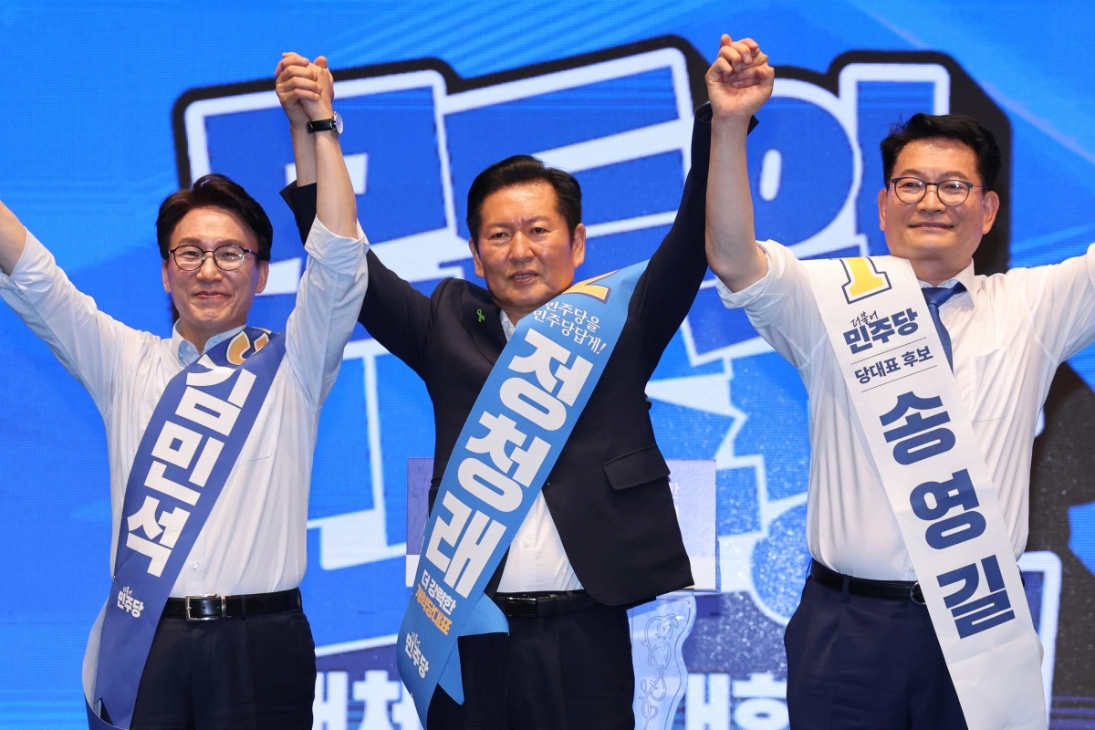 더불어민주당 당권 주자인 김민석(왼쪽부터), 정청래, 송영길 의원이 1일 충북 청주시 CJB미디어센터에서 열린 당대표·최고위원 합동연설회에서 손을 맞잡고 당원들에게 인사하고 있다. 2026.8.1 뉴스1