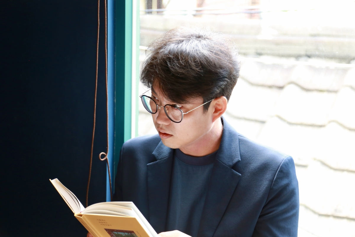 시인 박준이 새 산문집 ‘기쁨에도 슬픔에도 아랑곳없이’를 펼치고 있다. 난다 제공