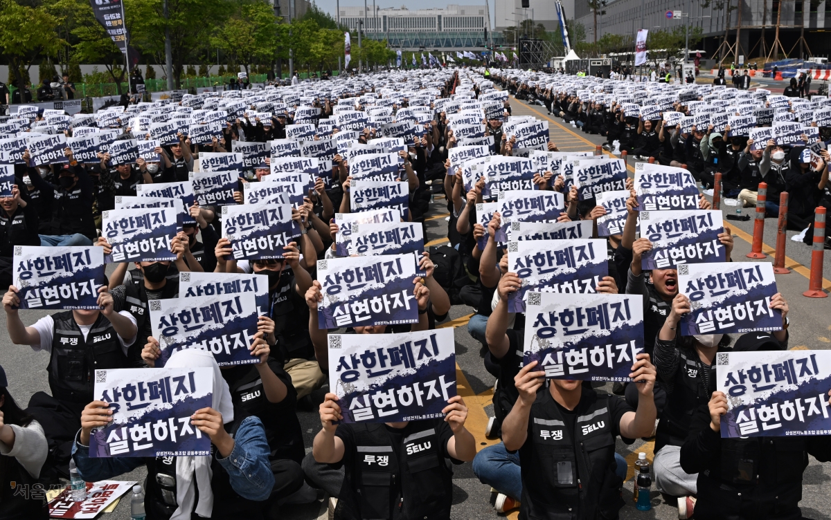 고용노동부가 ‘N% 성과급’ 요구와 기업의 공장 신설 등 경영상 결정은 의무적 교섭 대상이 아니라는 시행지침을 3일 내놓은 가운데 삼성전자 노조원들이 지난 4월 23일 경기 평택시 삼성전자 평택캠퍼스 앞에서 영업이익 연동 성과급을 요구하며 구호를 외치고 있다. 홍윤기 기자