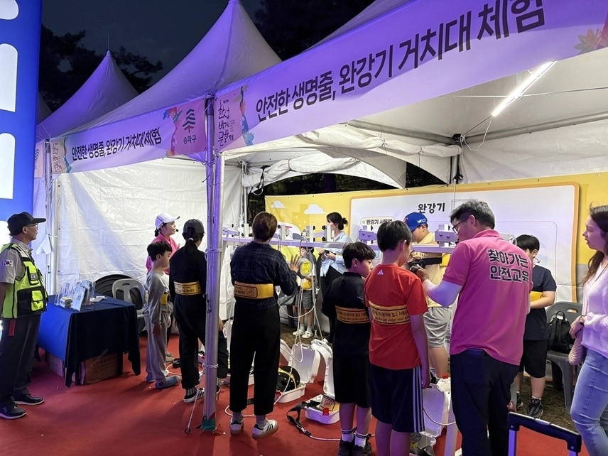 서울 송파구 구민이 한성백제문화제 현장에 마련된 안전체험 부스에서 완강기 체험을 해보고 있다. 송파구 제공