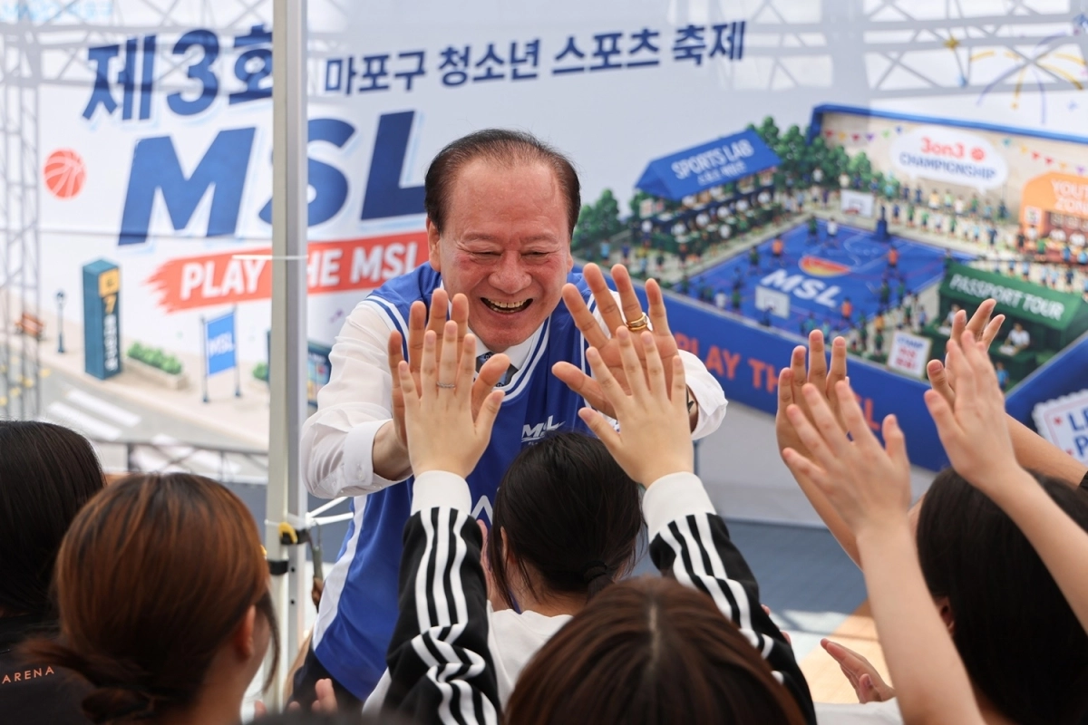 이달 5일 서울 마포구 홍익대 주변에서 열린 청소년 스포츠 축제에서 유동균 마포구청장이 청소년들과 하이파이브를 하고 있다. 마포구 제공